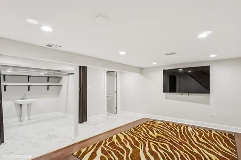 a view of a livingroom with wooden floor and a flat screen tv