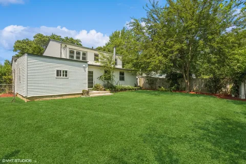 a view of a house with a backyard