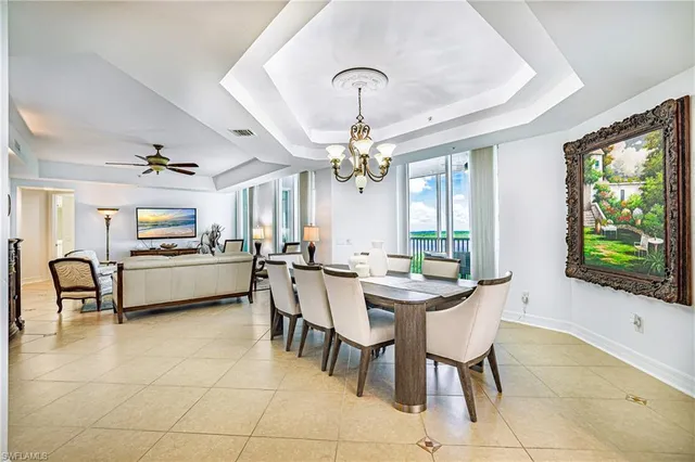 a view of a dining room with furniture and a chandelier