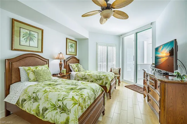 a bedroom with a bed and a flat tv screen on the dresser