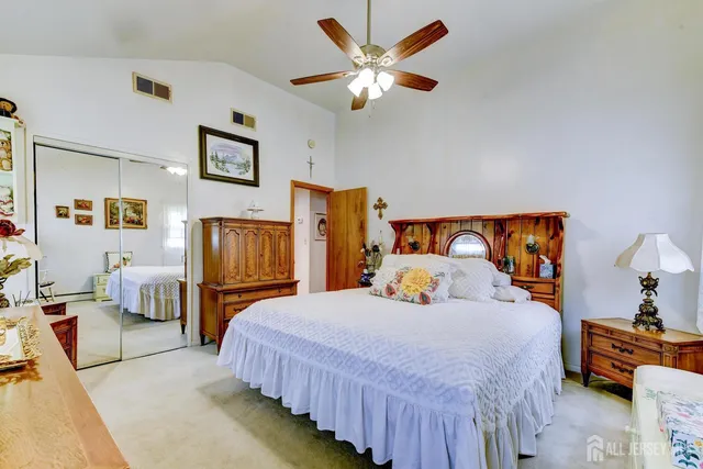 a bedroom with a bed couch and dresser