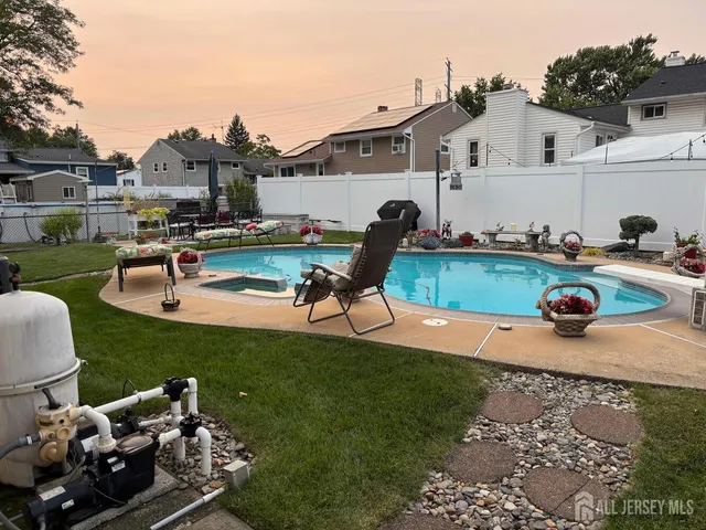a view of a house with backyard space and sitting area