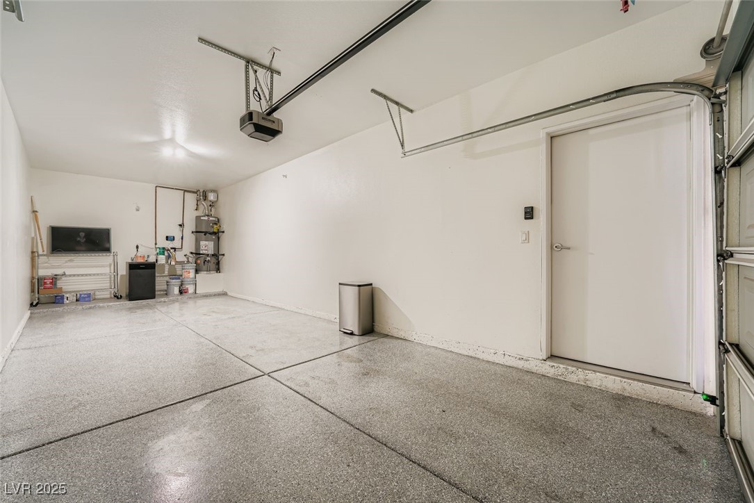 10550 West Alexander Road, Unit 2219 Las Vegas, NV 89129 - Photo 22 of 29 Garage featuring water heater and a garage door opener