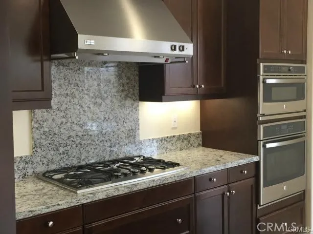 a stove top oven sitting inside of a kitchen