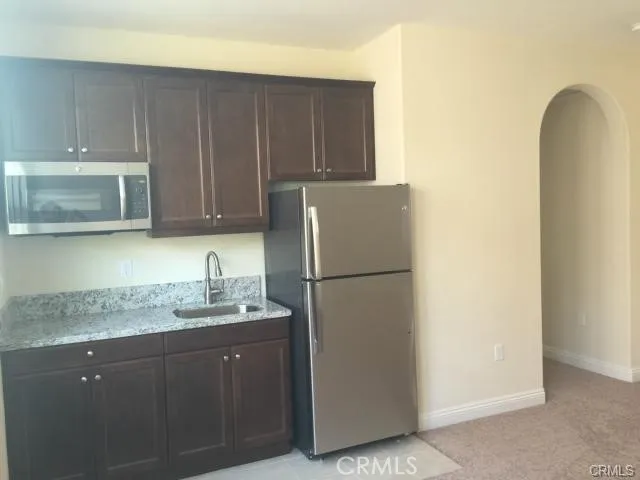 a kitchen with a sink and a refrigerator