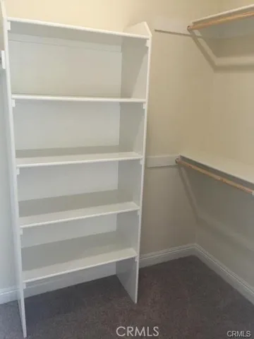 a view of walk in closet with empty racks