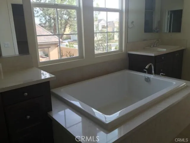 a bath tub sitting in a bathroom next to a window