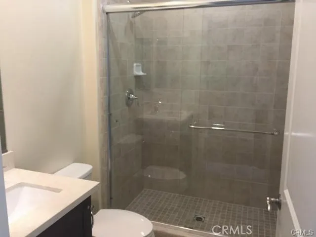 a bathroom with a shower and a toilet