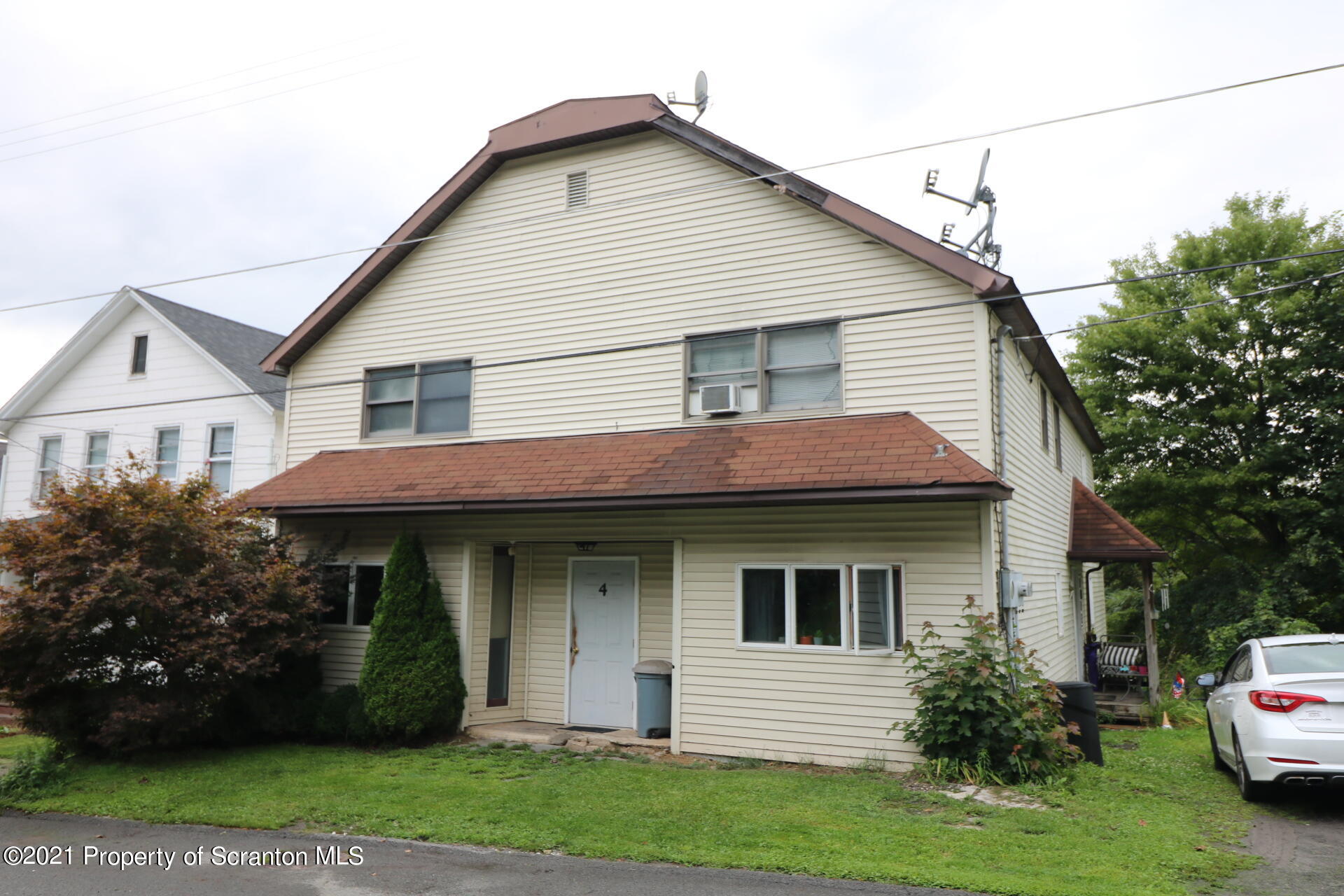4 Prospect Street Simpson, PA 18407 - Photo 2 of 41 a front view of a house with a garden
