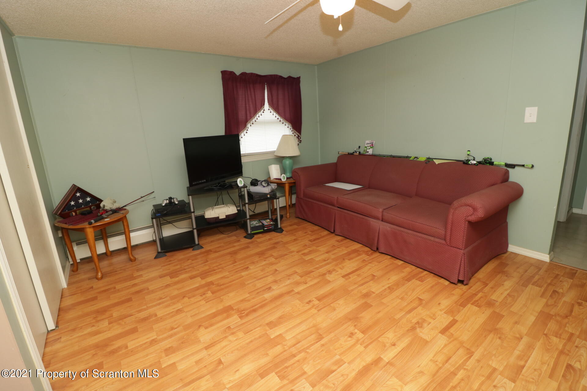 4 Prospect Street Simpson, PA 18407 - Photo 23 of 41 a living room with furniture and a flat screen tv