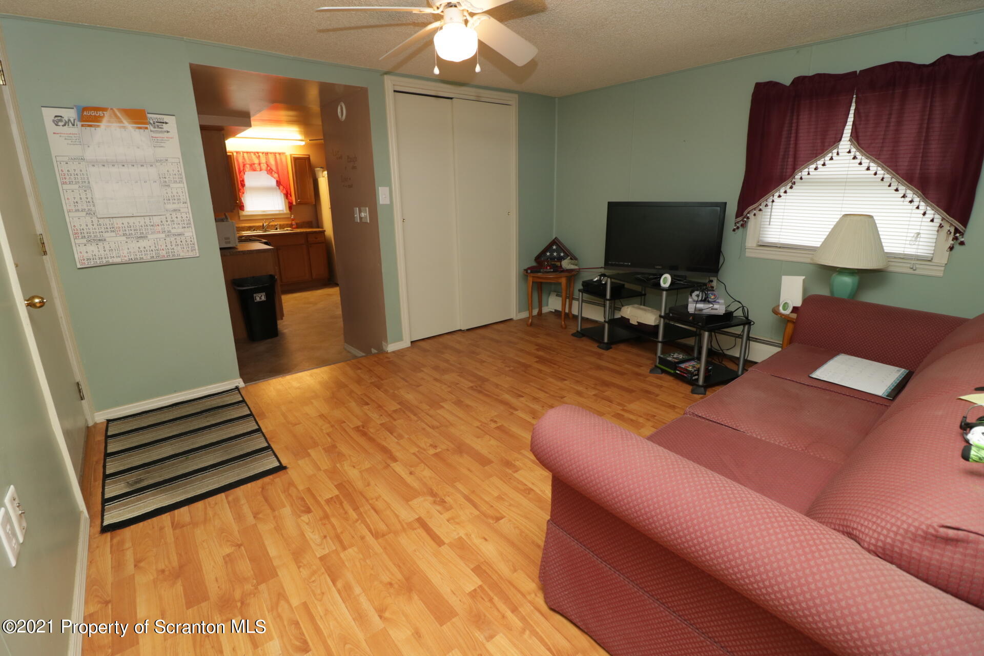 4 Prospect Street Simpson, PA 18407 - Photo 24 of 41 a bedroom with a bed and a chandelier
