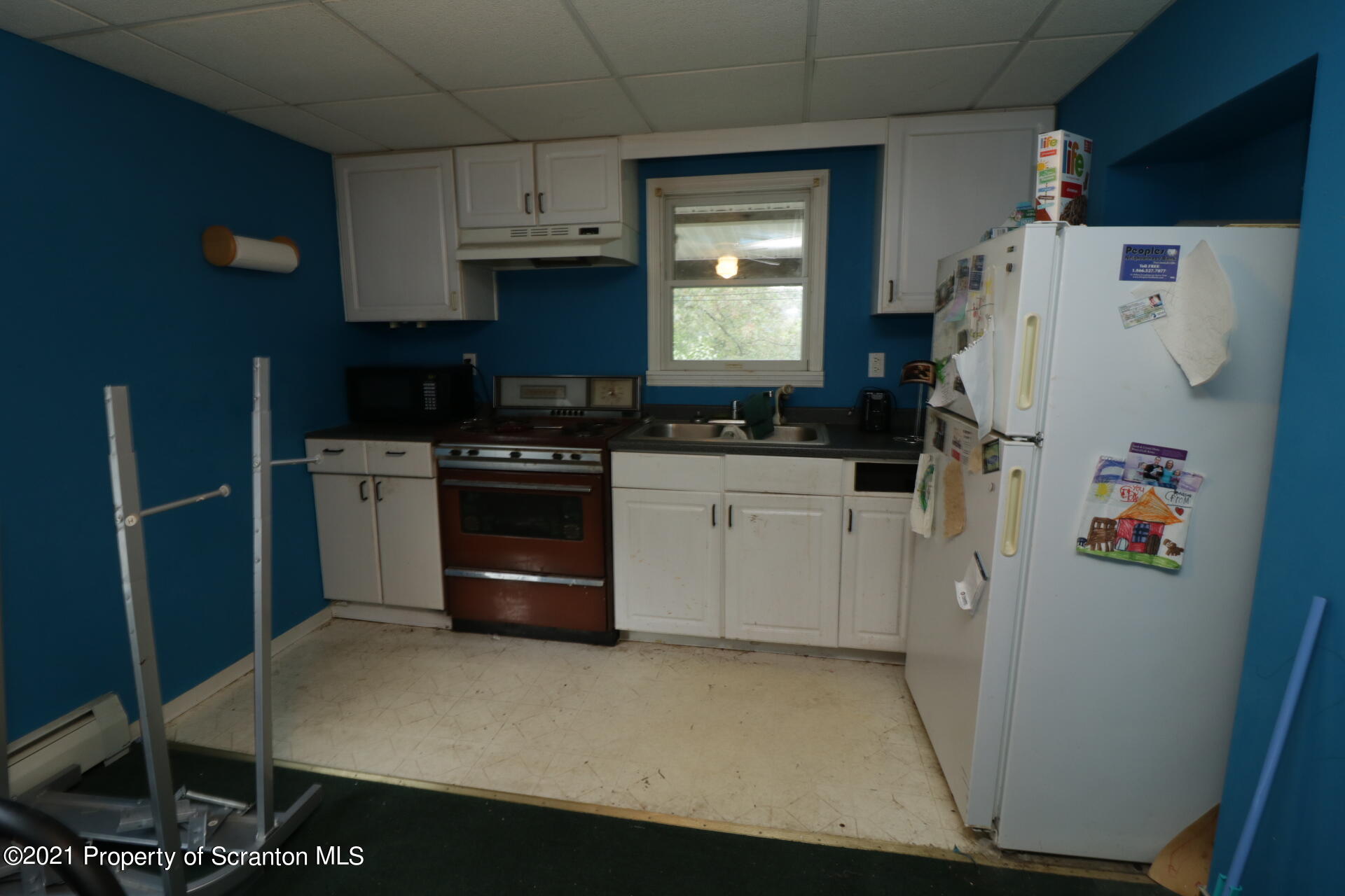 4 Prospect Street Simpson, PA 18407 - Photo 36 of 41 a kitchen with a refrigerator a stove top oven a sink and cabinets