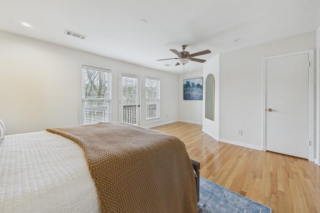 100 Colony Ridge Drive Alpharetta, GA 30022 - Photo 20 of 47 a spacious bedroom with a large bed a chandelier and a window