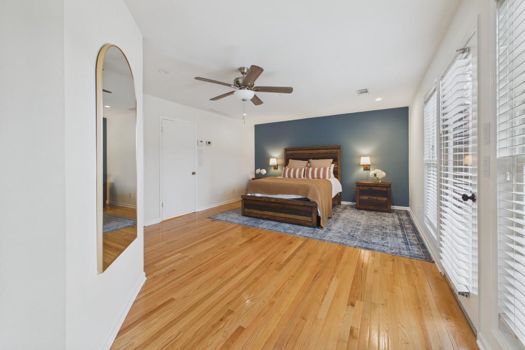 100 Colony Ridge Drive Alpharetta, GA 30022 - Photo 22 of 47 a spacious bedroom with a bed and a chandelier