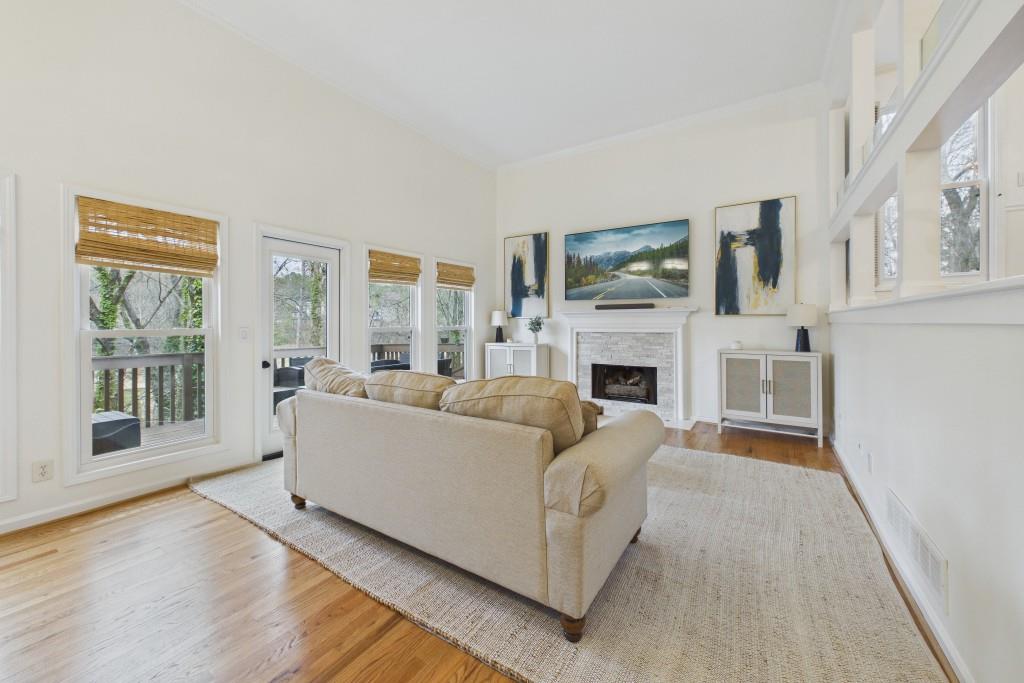 100 Colony Ridge Drive Alpharetta, GA 30022 - Photo 4 of 47 a living room with furniture a flat screen tv and a fireplace