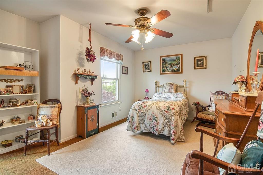 67 Redbud Road Piscataway, NJ 08854 - Photo 15 of 23 a bedroom with a bed and a chandelier