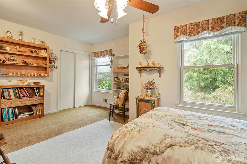 67 Redbud Road Piscataway, NJ 08854 - Photo 17 of 23 a bedroom with a bed a large window and a chandelier