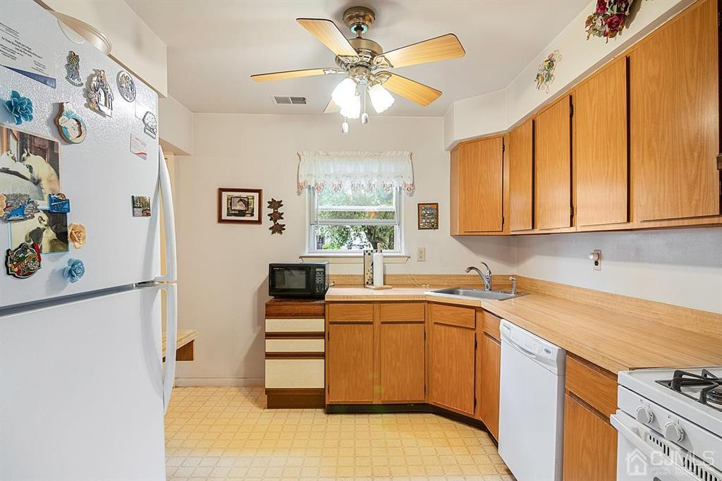 67 Redbud Road Piscataway, NJ 08854 - Photo 8 of 23 a kitchen with stainless steel appliances a sink a stove a refrigerator and cabinets