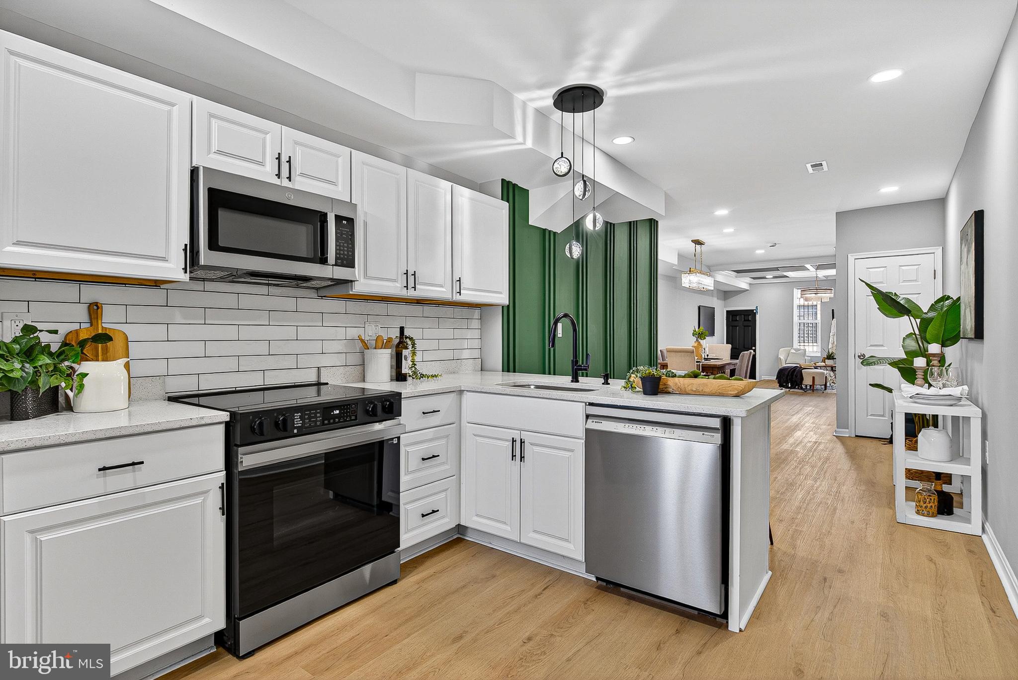 a kitchen with stainless steel appliances granite countertop a stove and a sink
