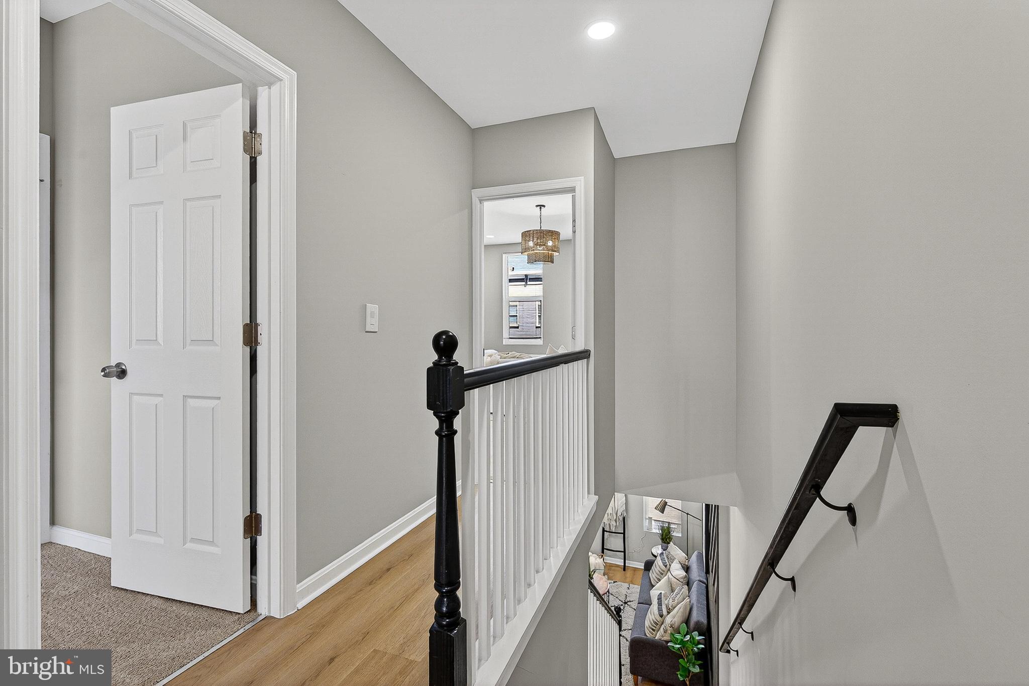 1725 East Oliver Street Baltimore, MD 21213 - Photo 13 of 30 a view of a hallway with wooden floor and stairs