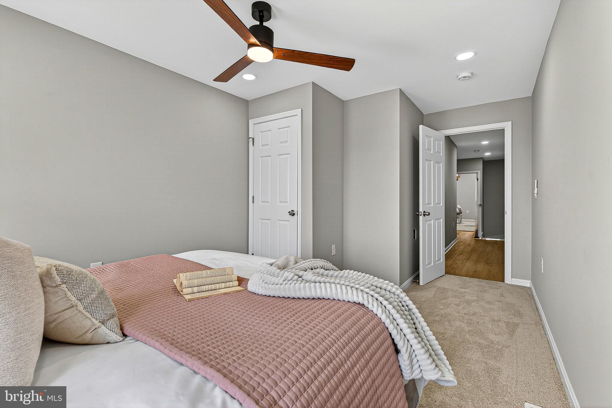 1725 East Oliver Street Baltimore, MD 21213 - Photo 18 of 30 a bedroom with a large bed and a chandelier