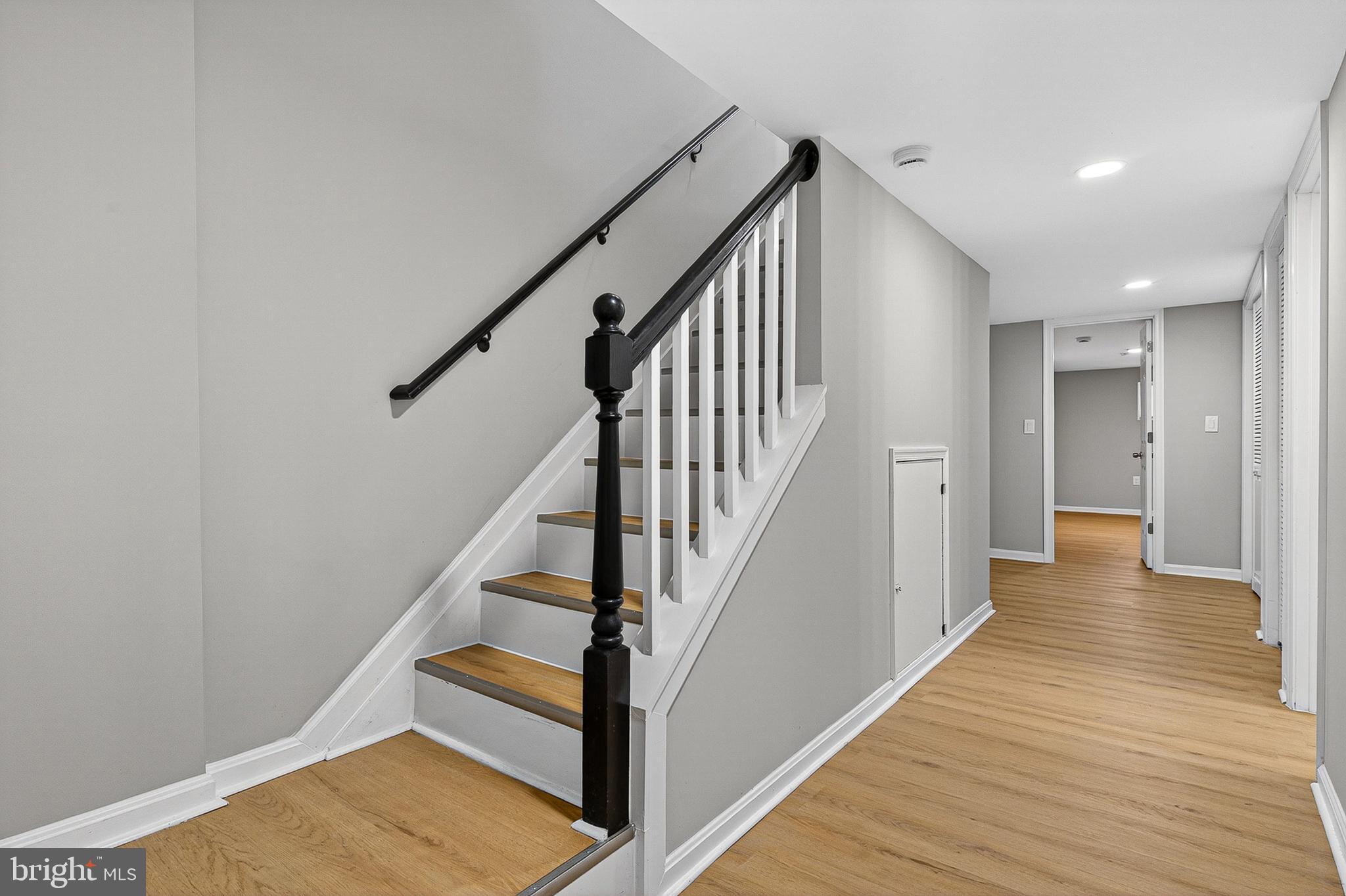 1725 East Oliver Street Baltimore, MD 21213 - Photo 23 of 30 a view of staircase with wooden floor and white walls