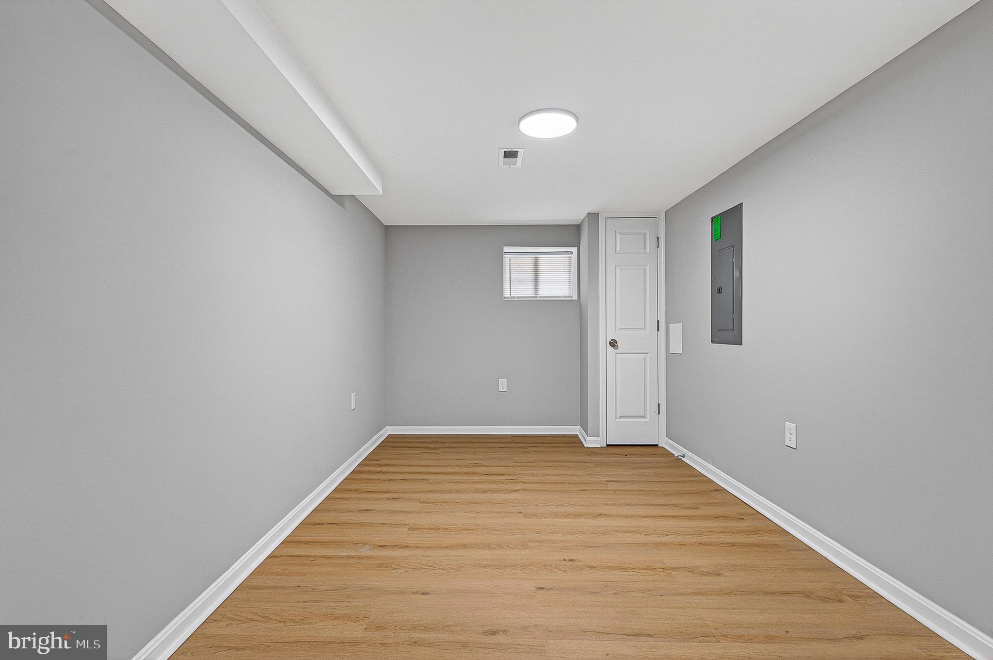 1725 East Oliver Street Baltimore, MD 21213 - Photo 27 of 30 a view of a big room with wooden floor and windows