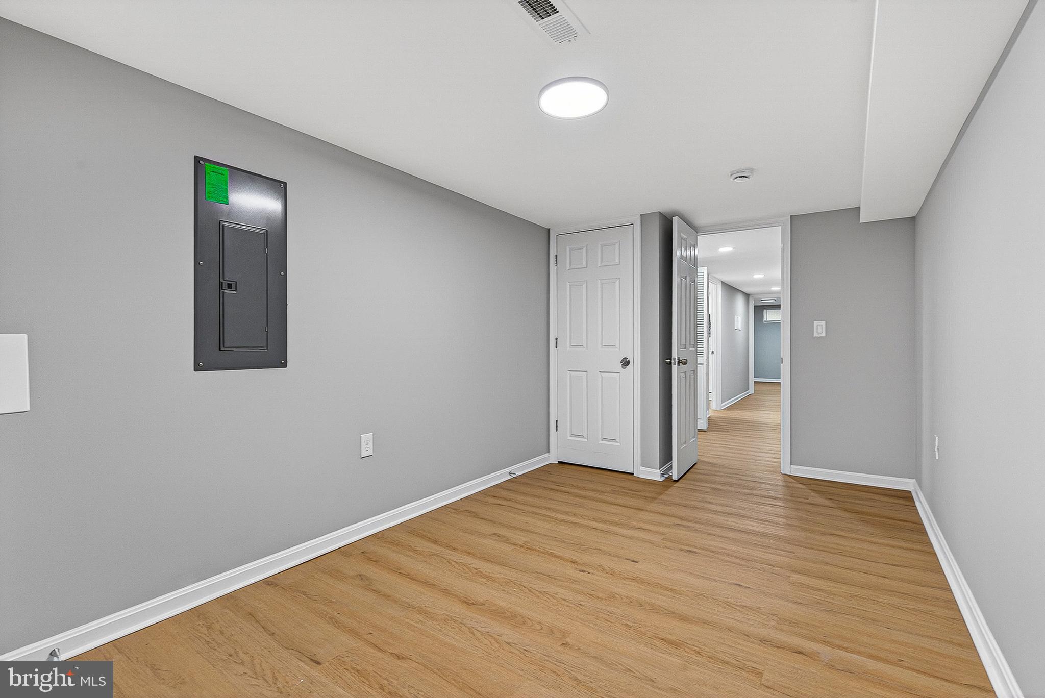 1725 East Oliver Street Baltimore, MD 21213 - Photo 28 of 30 a view of an empty room with wooden floor and a window