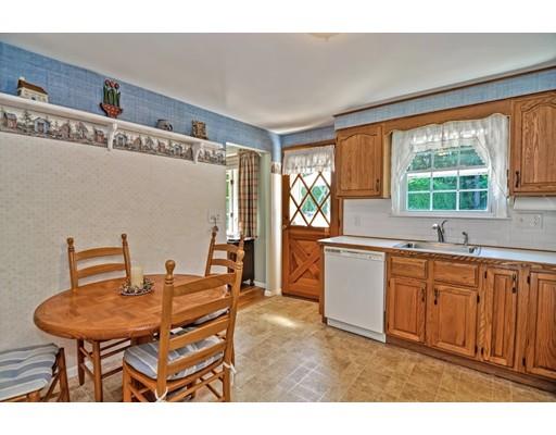 48 Everett Circle Stoughton, MA 02072 - Photo 11 of 34 a open kitchen with stainless steel appliances granite countertop a sink a stove a dining table and chairs