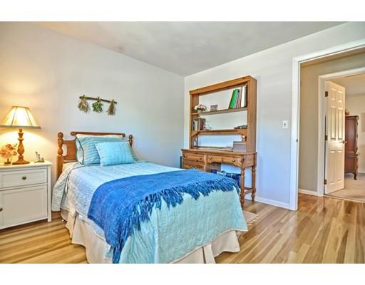 48 Everett Circle Stoughton, MA 02072 - Photo 13 of 34 a bedroom with a bed and wooden floor