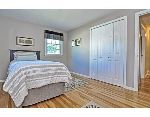 48 Everett Circle Stoughton, MA 02072 - Photo 15 of 34 a bedroom with a bed and wooden floor