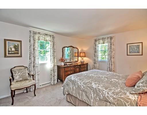 48 Everett Circle Stoughton, MA 02072 - Photo 16 of 34 a bedroom with a bed large window with table and chair