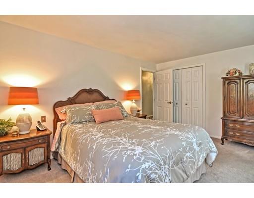 48 Everett Circle Stoughton, MA 02072 - Photo 17 of 34 a bedroom with a bed and wooden floor