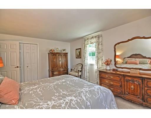 48 Everett Circle Stoughton, MA 02072 - Photo 18 of 34 a bedroom with a bed and a dresser