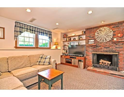 48 Everett Circle Stoughton, MA 02072 - Photo 21 of 34 a living room with furniture a flat screen tv and a fireplace