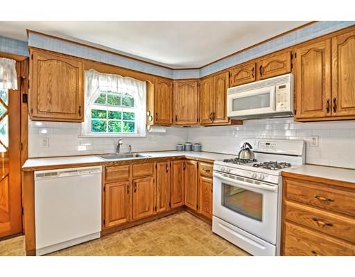 48 Everett Circle Stoughton, MA 02072 - Photo 10 of 34 a kitchen with stainless steel appliances granite countertop a stove a sink and a microwave