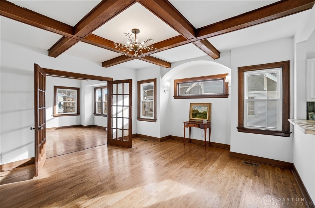 25 Englewood Road Springfield, OH 45504 - Photo 10 of 66 Elegant living space featuring exposed ceiling beams and shining hardwood floors.