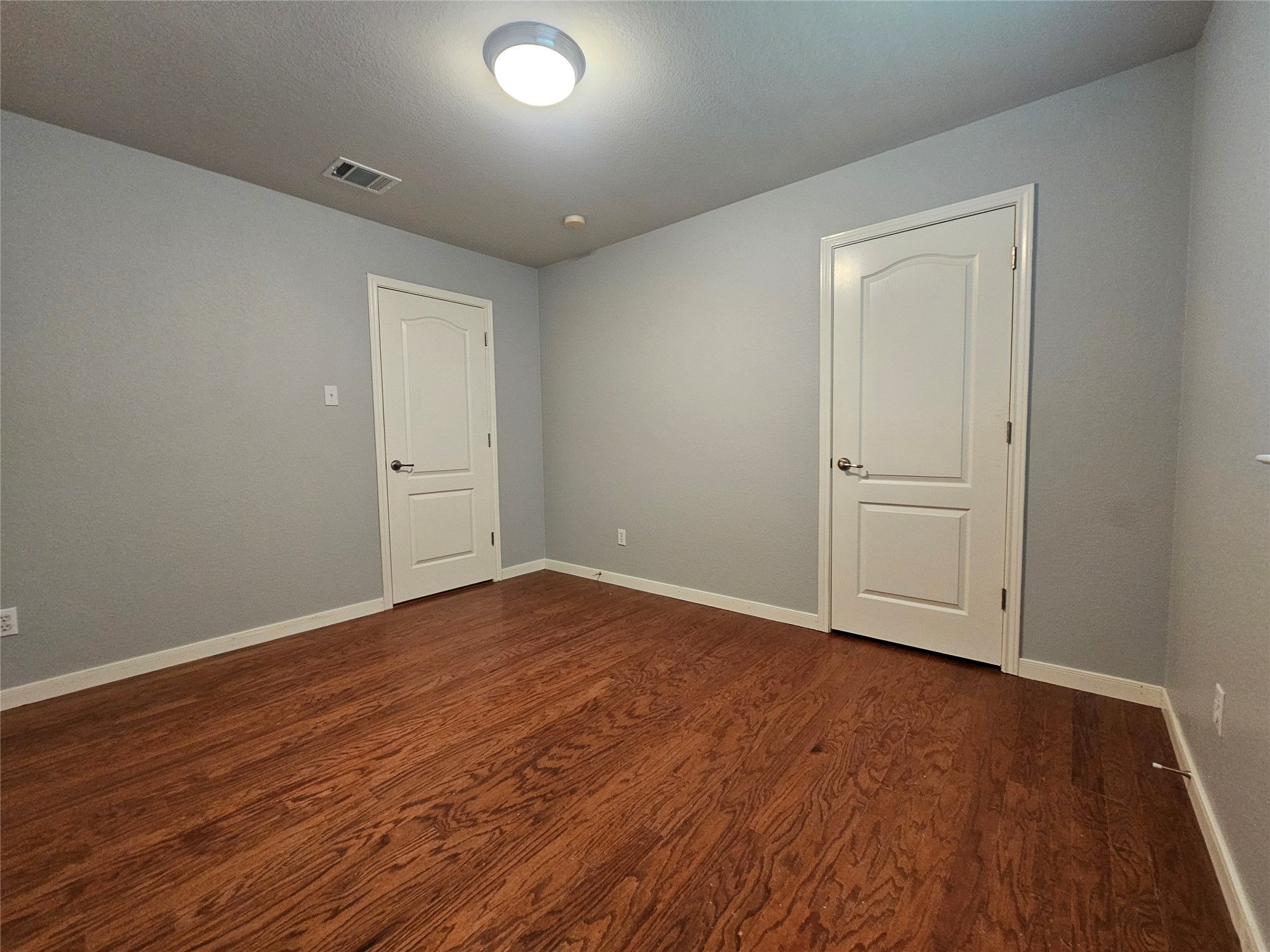 2035 Intrepid Drive Buda, TX 78610 - Photo 18 of 26 Rich hardwood floors create a welcoming atmosphere in this versatile room.