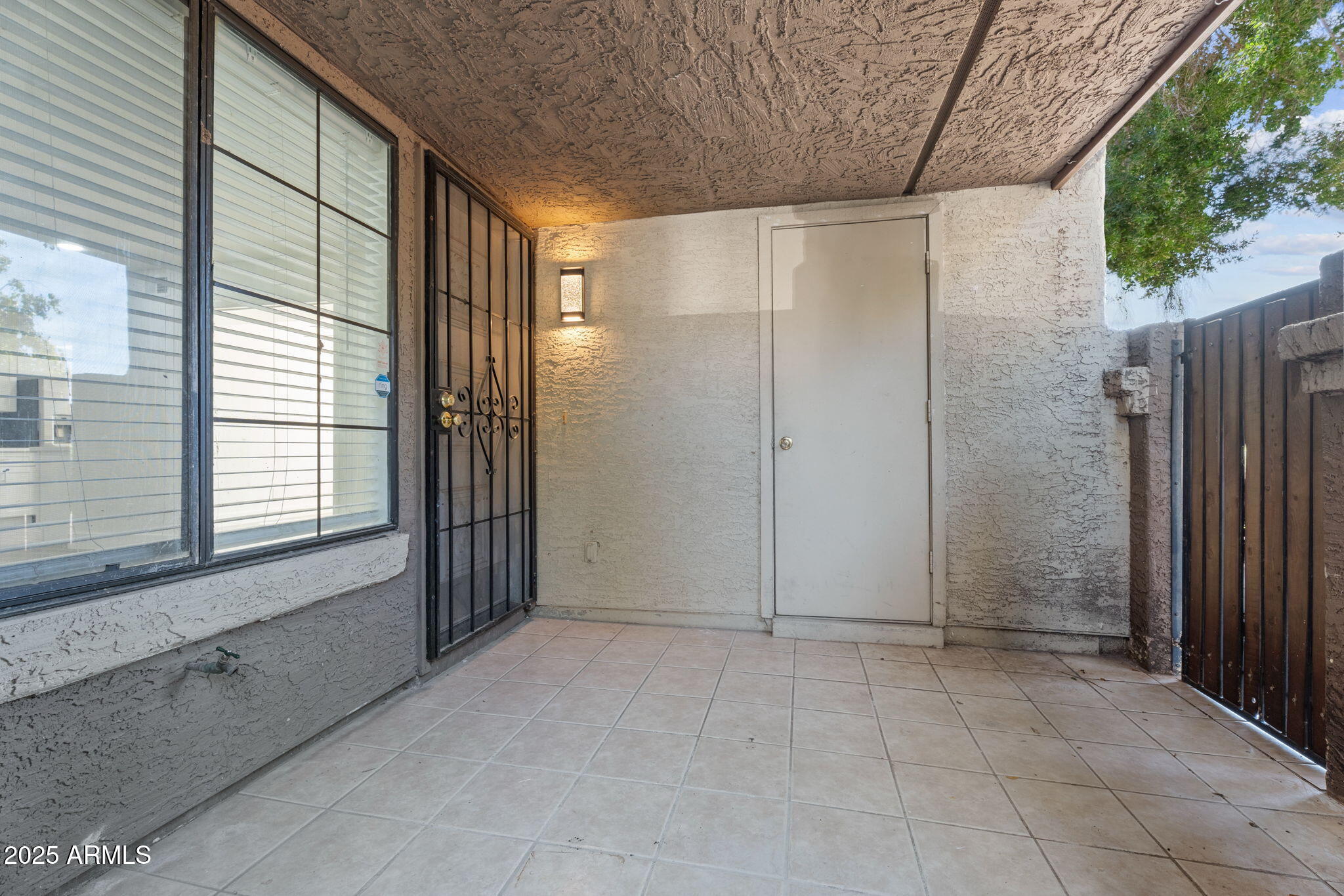 1905 East University Drive, Unit 133 Tempe, AZ 85288 - Photo 12 of 38 an empty room with a outdoor space