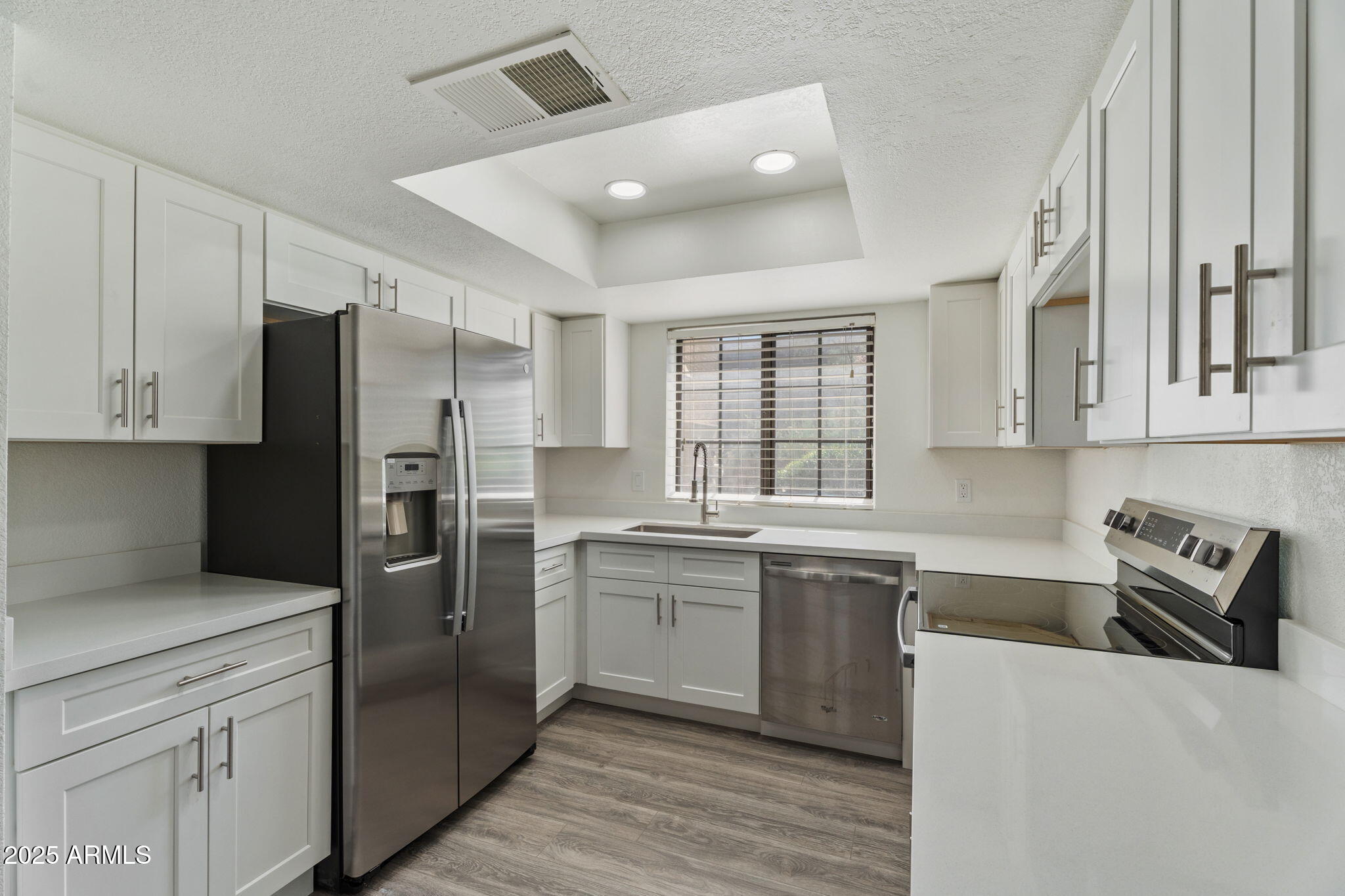 1905 East University Drive, Unit 133 Tempe, AZ 85288 - Photo 13 of 38 a kitchen with stainless steel appliances granite countertop a refrigerator and a sink