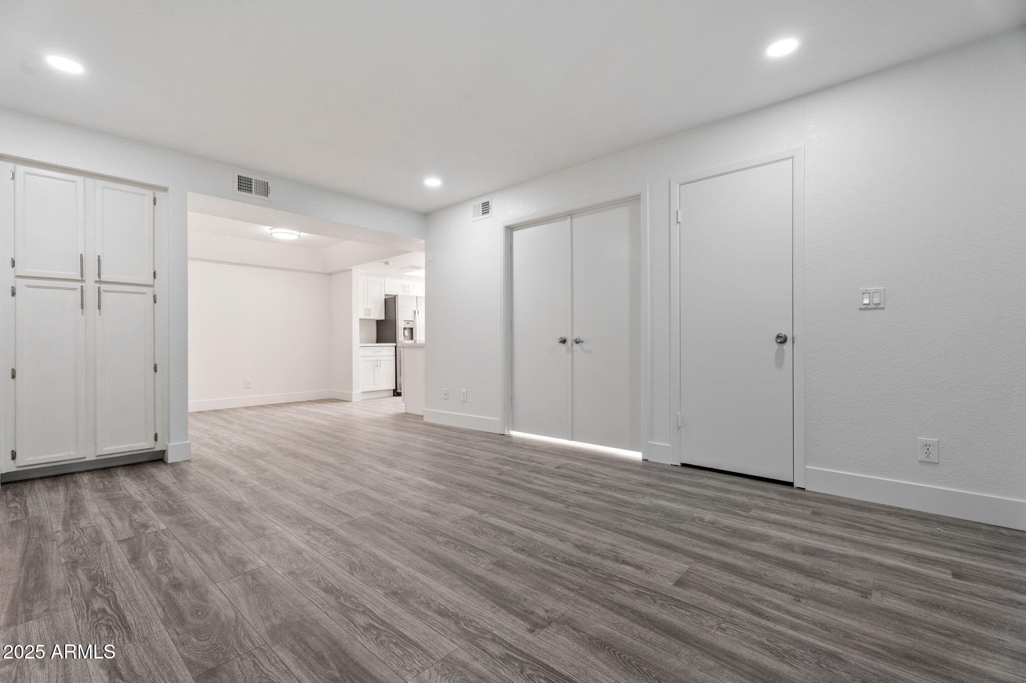 1905 East University Drive, Unit 133 Tempe, AZ 85288 - Photo 17 of 38 a view of empty room with wooden floor
