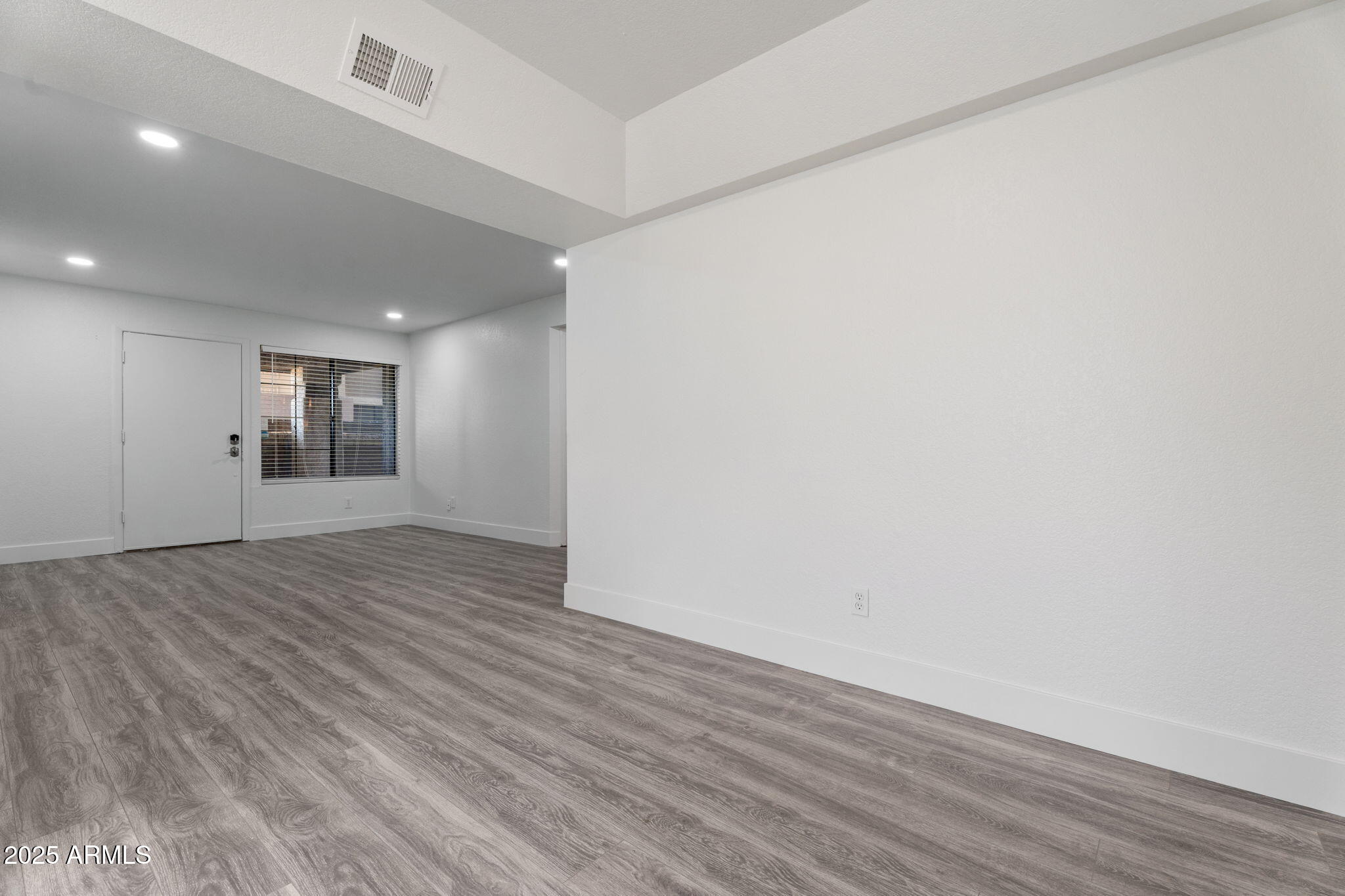 1905 East University Drive, Unit 133 Tempe, AZ 85288 - Photo 18 of 38 an empty room with wooden floor and windows