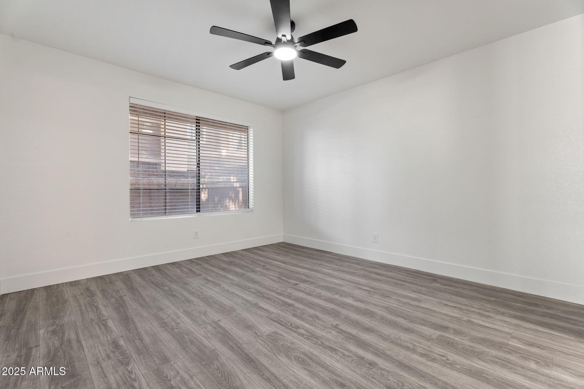 1905 East University Drive, Unit 133 Tempe, AZ 85288 - Photo 25 of 38 wooden floor in an empty room with a window