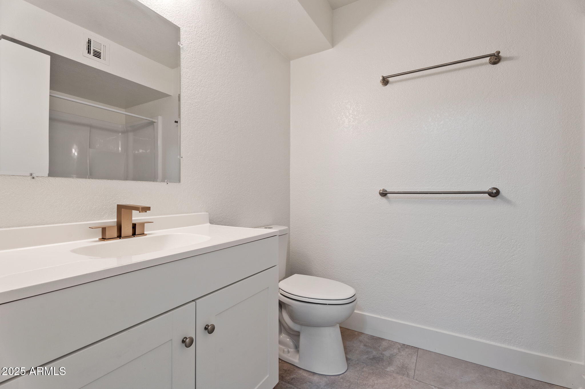 1905 East University Drive, Unit 133 Tempe, AZ 85288 - Photo 27 of 38 a bathroom with a sink a toilet and a mirror