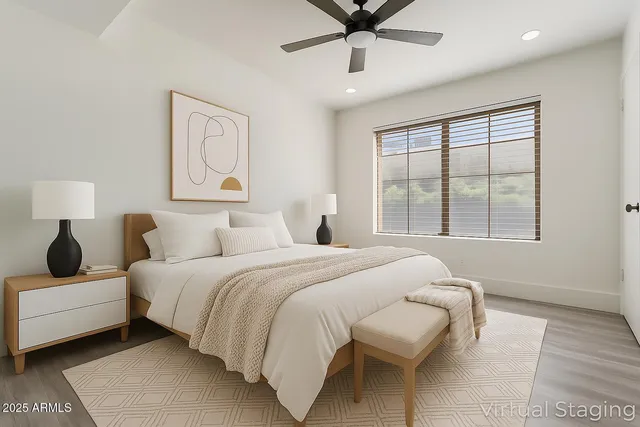 a bedroom with a bed and wooden floor
