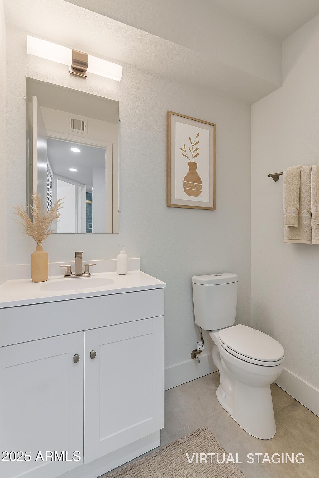 1905 East University Drive, Unit 133 Tempe, AZ 85288 - Photo 6 of 38 a bathroom with a toilet sink and mirror
