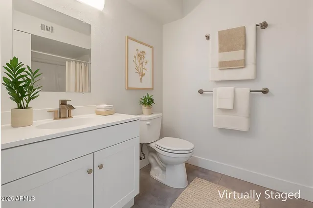 a bathroom with a sink toilet and a mirror