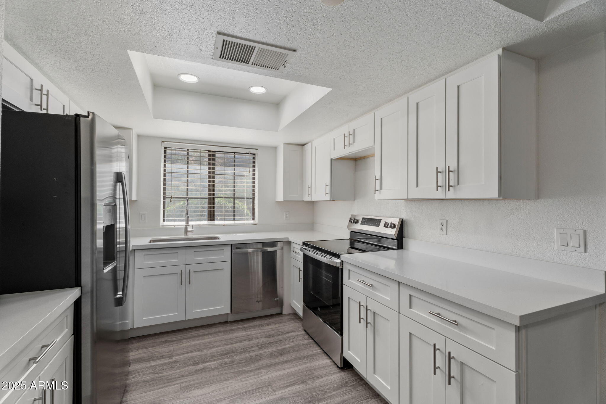 1905 East University Drive, Unit 133 Tempe, AZ 85288 - Photo 10 of 38 a kitchen with a sink stove and refrigerator