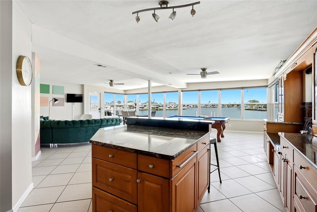 2311 Bay Boulevard Indian Rocks Beach, FL 33785 - Photo 10 of 80 a kitchen with stainless steel appliances granite countertop a sink and a stove