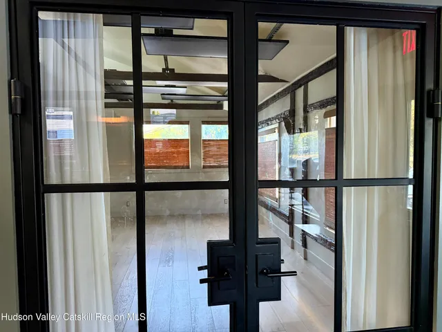 a view of a livingroom with wooden floor and furniture